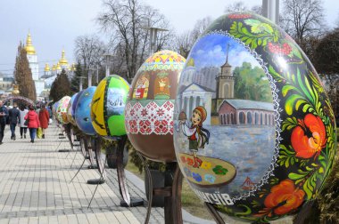Big painted Easter eggs installations presented on the square, people walking around. Festival of Folk art. April 18, 2018. Kyiv, Ukraine