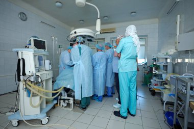 At the operating theatre. Surgeons standing around patient plate and performing an operation. January 12, 2019. Kiev regional clinic 1. Kiev, Ukraine
