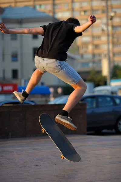 Young boy skateboarding jumping on the street. May 29, 2012. Kyiv, Ukraine