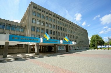 Facade of main building of Uzhgorod National University, main entrance, Ukrainian flags. September 3, 2018. Uzhgorod, Ukraine