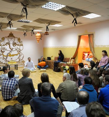 Krishna followers sitting on a floor in a temple and listening to guru. April 3, 2013. Kyiv, Ukraine