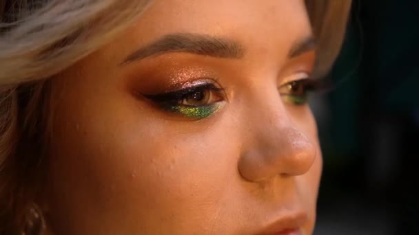 Beautiful female eye blinking. Close up of amazing, trendy makeup in green colors. — Stock Video
