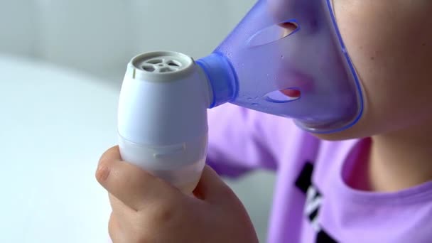 Close up view of inhaler mask when little girl makes inhalation with medical nebulizer — Video