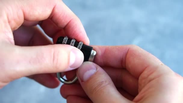 Close-up of mans hand opening combination lock. Concept of cyber security, safety — Stock Video