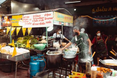 BANGKOK, THAILAND - 10 Ekim 2021: Bir şef Bangkok 'taki ünlü Çin Mahallesi olan Yaowarat Yolu' nda vejetaryen festivalinde yemek pişiriyor..