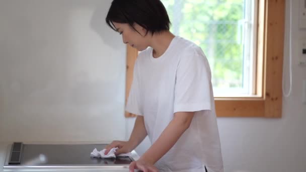 Woman Wiping Cooking Heater — Stock Video