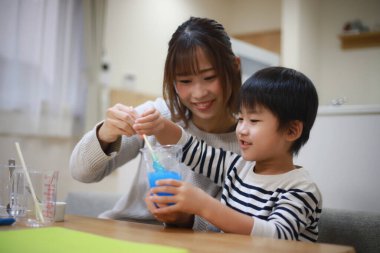 Parent and child making slime 