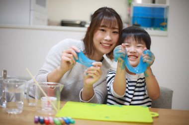 Parent and child making slime 