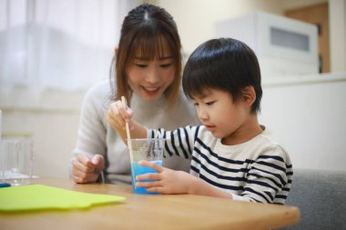 Parent and child making slime 