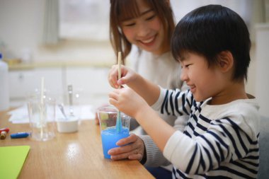 Parent and child making slime 