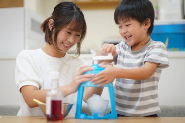 Parents and children making shaved ice 