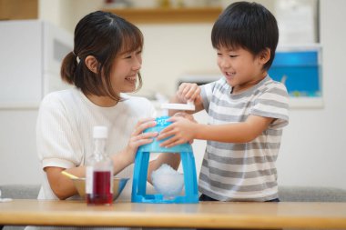 Parents and children making shaved ice 