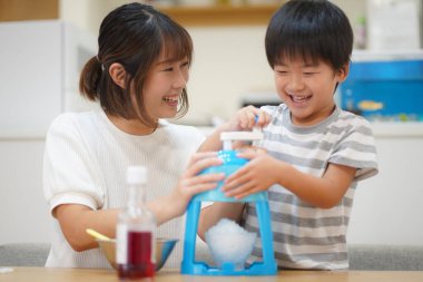 Parents and children making shaved ice 