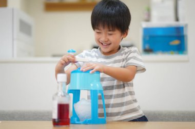 Boy making shaved ice 