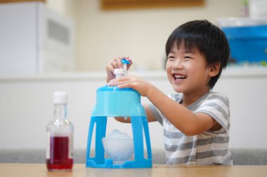 Boy making shaved ice 