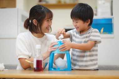 Parents and children making shaved ice 