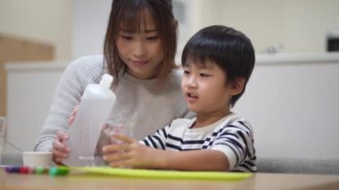 Parent and child making slime 