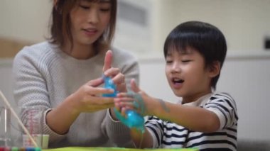 Parent and child making slime 