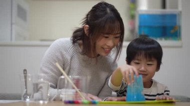 Parent and child making slime 