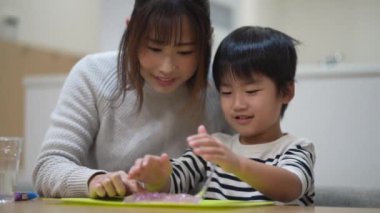 Parent and child making slime 