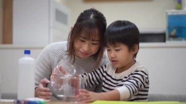 Parent and child making slime 