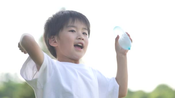 Boy Playing Water Balloons — Wideo stockowe