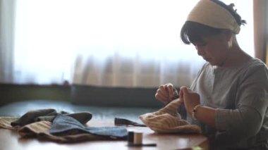 Woman handcrafting a bag 