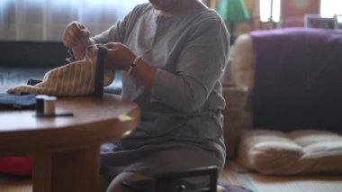 Woman handcrafting a bag 