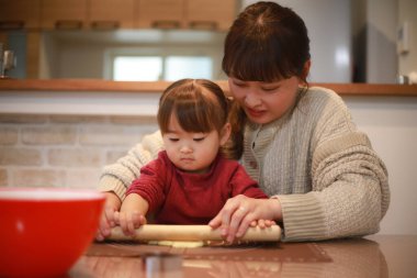 Parents and children making sweets 