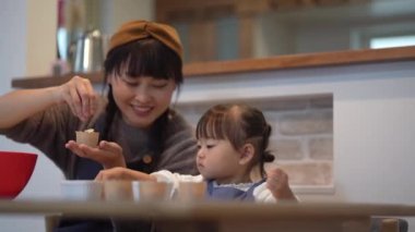 Parents and children making sweets 