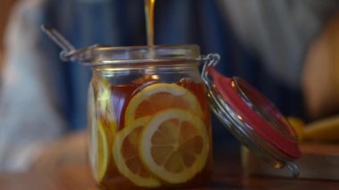 A woman making honey pickles of lemon 
