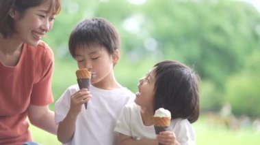 Parents and children eating soft serve ice cream
