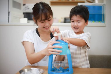Parents and children making shaved ice 