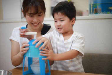 Parents and children making shaved ice 