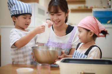 Image of parents and children cooking 