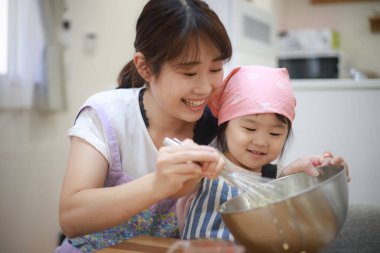 Image of parents and children cooking 