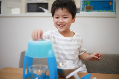 Image of a boy making shaved ice 