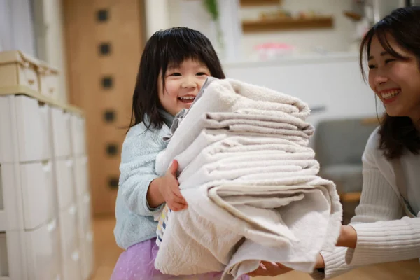 Girl Carrying Folded Laundry — Stok fotoğraf