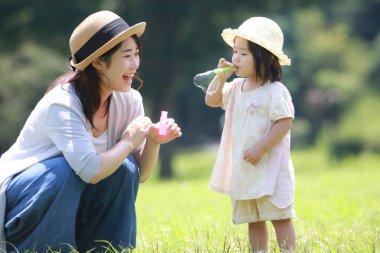 Image of parents and children playing with soap bubbles