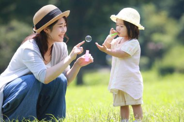 Image of parents and children playing with soap bubbles