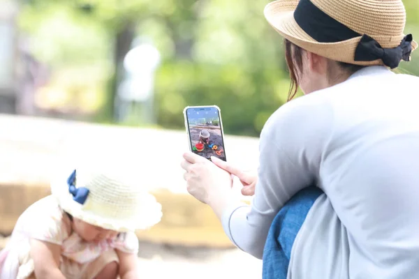 Mother Taking Picture Child Playing Sandbox Smartphone —  Fotos de Stock