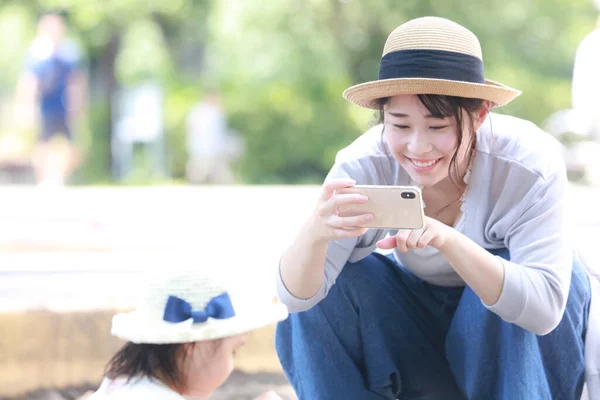 Mother Taking Picture Child Playing Sandbox Smartphone — Stockfoto