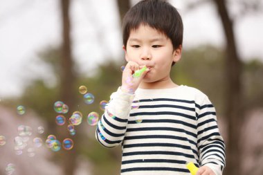 Image of a boy blowing a shabon ball 