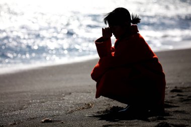 Image of a depressed woman on the beach 