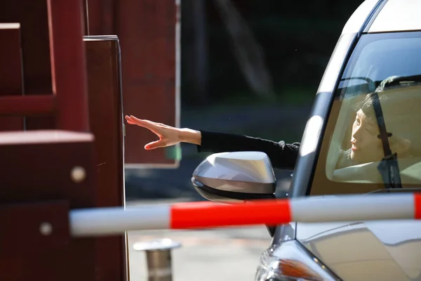 A woman reaching out and taking a parking ticket