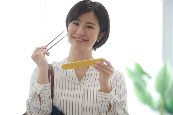 Woman Taking Out Chopsticks Bag — Stock Fotó