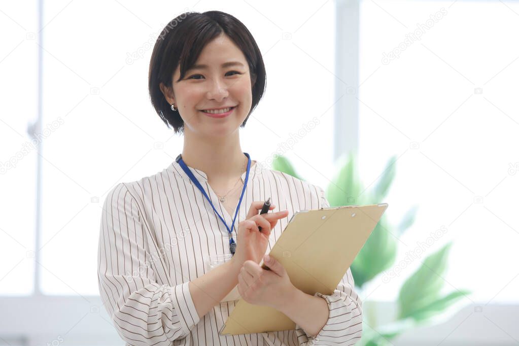 Female employee with a binder 