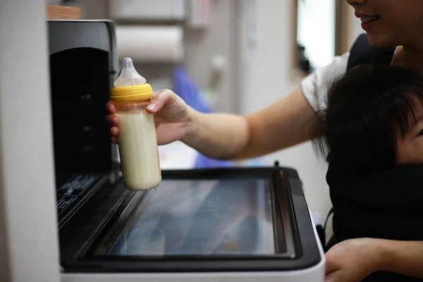 Woman Putting Bottle Milk Microwave — Stock Photo, Image