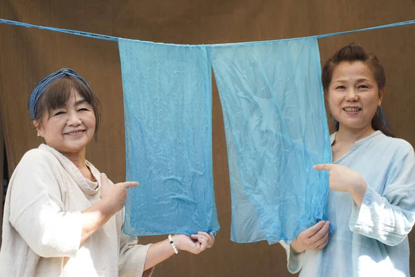 Japanese Senior Women Holding Indigo Dyed Silk — стоковое фото