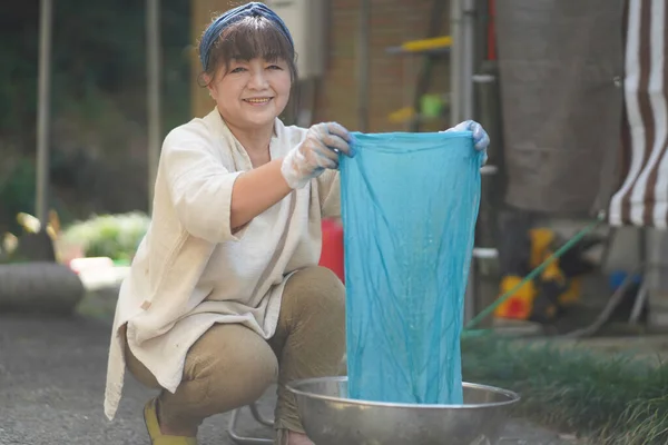 Japanese Senior Woman Dyeing Cloth Indigo Color — стоковое фото